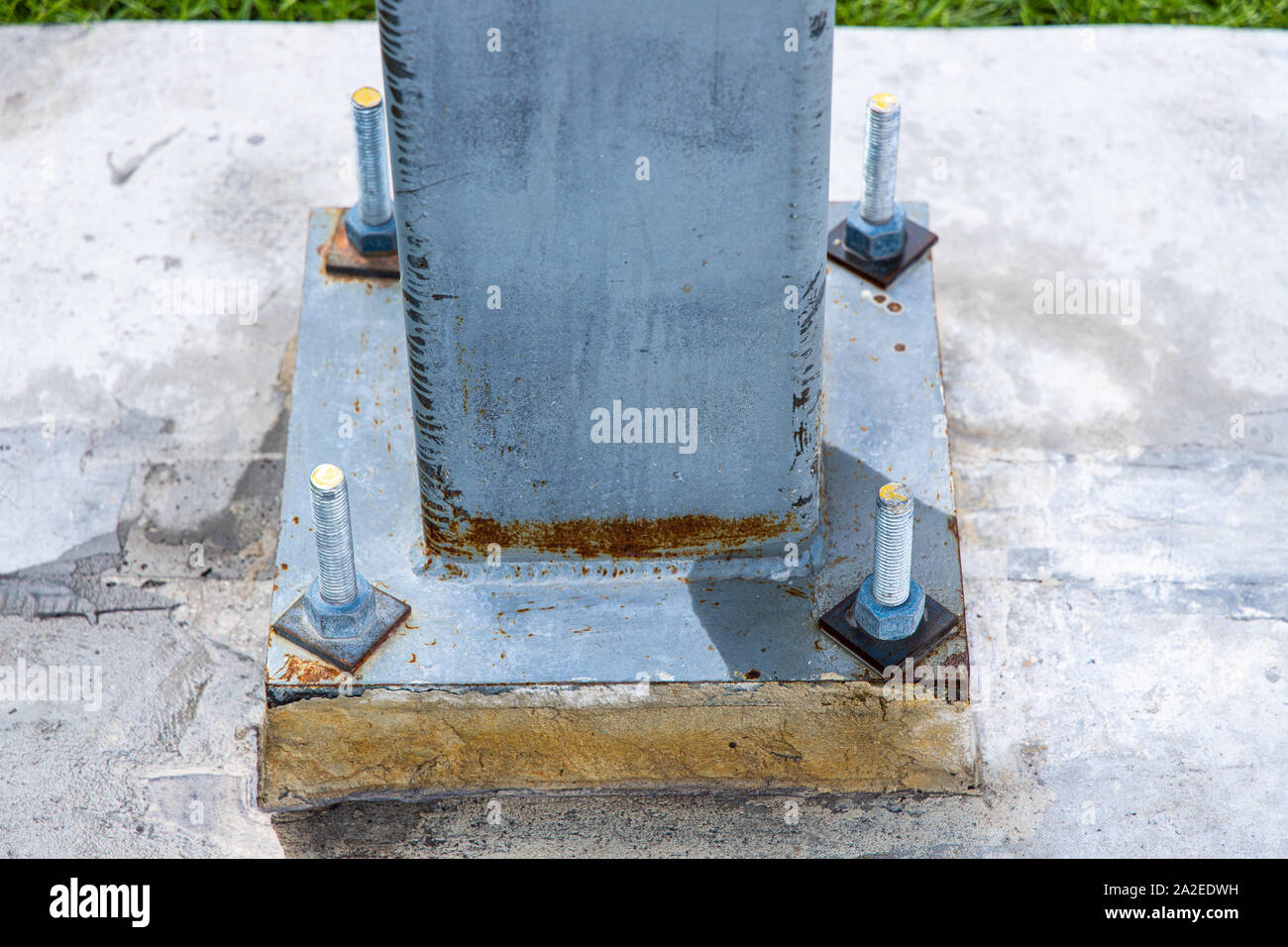strong bolts holding down steel leg Stock Photo Alamy