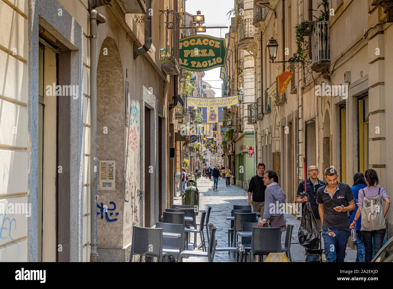 People walking down  Via Porta Palatina a narrow street in Turin ,Italy Stock Photo