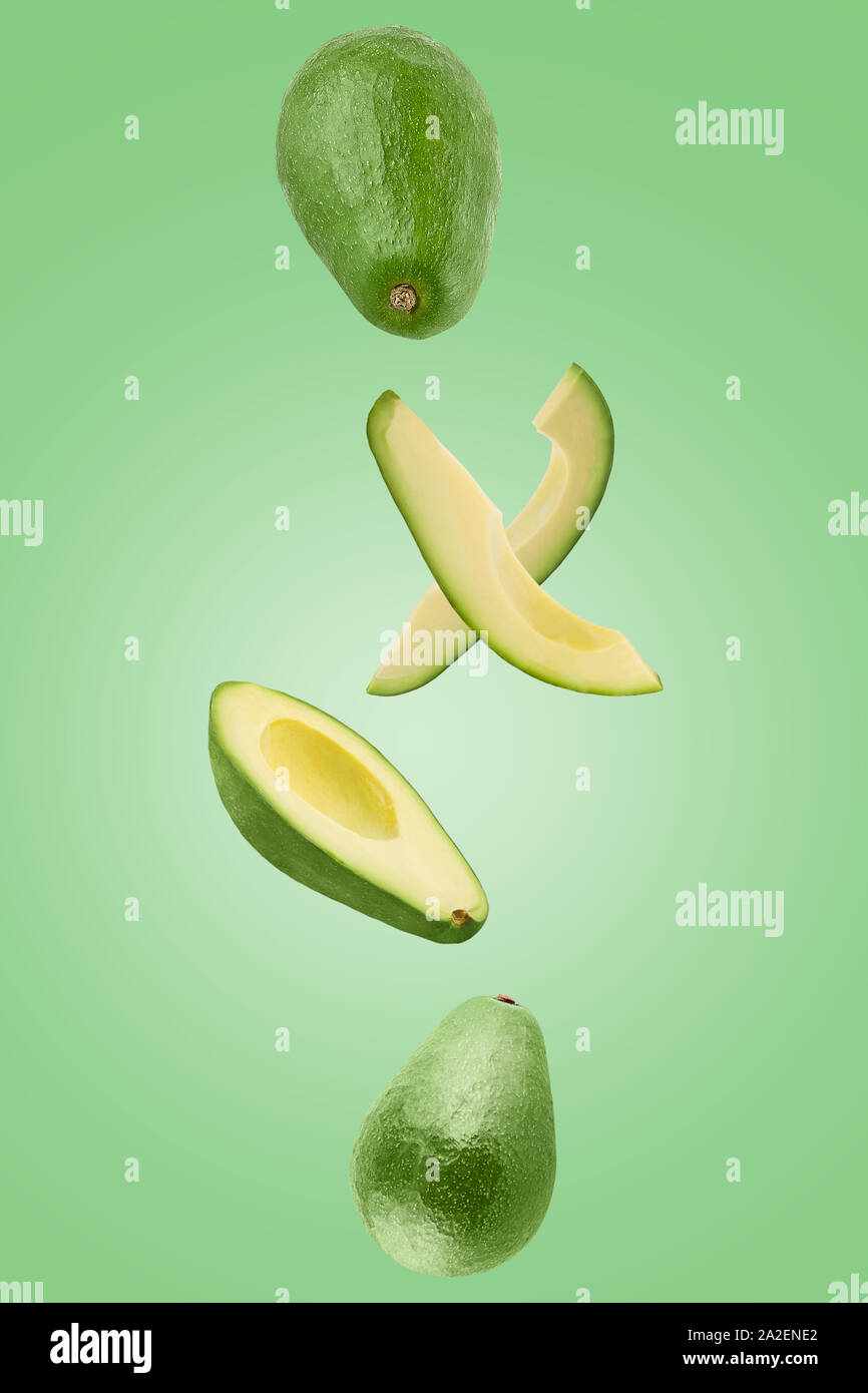 Sliced Avocado isolated in green surface viewed from above Stock Photo