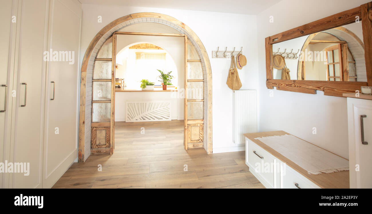 Big wooden handmade mirror in hallway boho interior. Home indoors design concept. Stock Photo