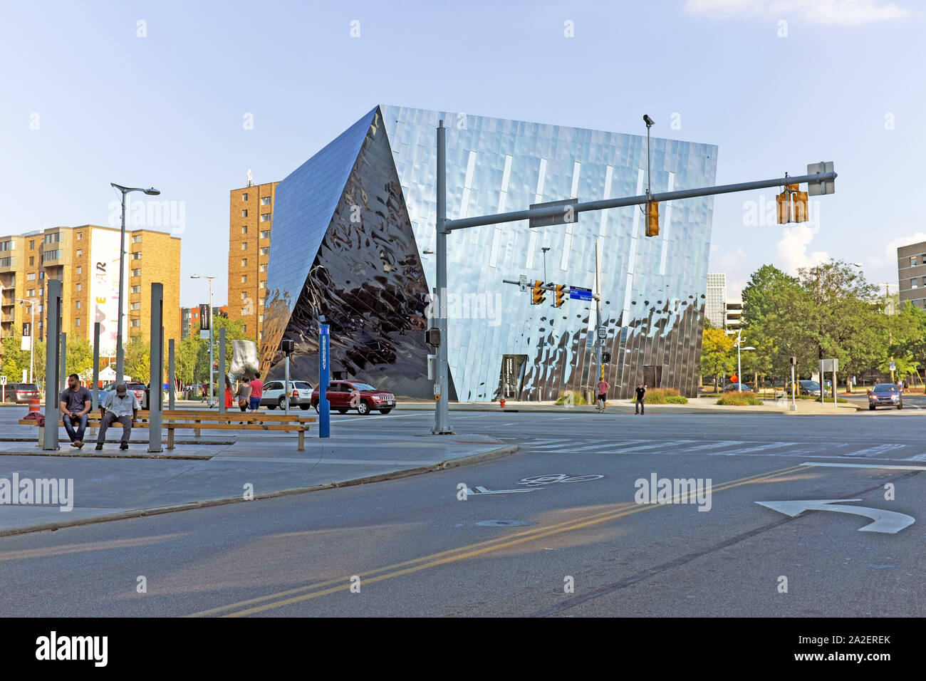 Two guys sit on a bench on Euclid Avenue across from the Cleveland Museum of Contemporary Art in the University Circle district of Cleveland, Ohio, US Stock Photo