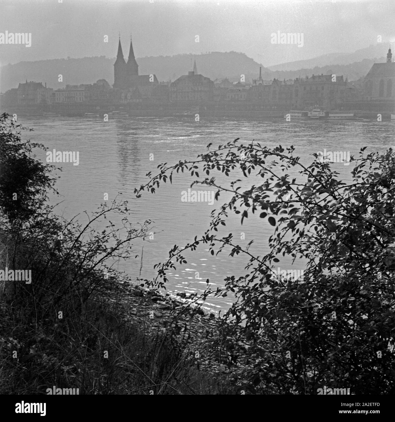 Der Rhein bei Bingen mit der Kirche St. Hildegard und der Skyline im Morgennebel, Deutschland 1930er Jahre. River Rhine at Bingen with St. Hildegard's church and the skyline in the morning fog, Germany 1930s. Stock Photo