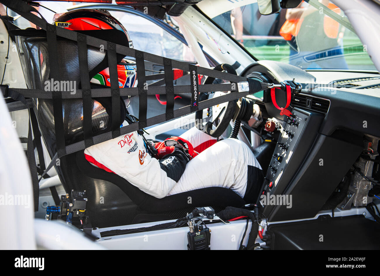 Vallelunga, Italy september 14 2019. Touring racing car cockpit with race driver sitting ready for the race side view Stock Photo