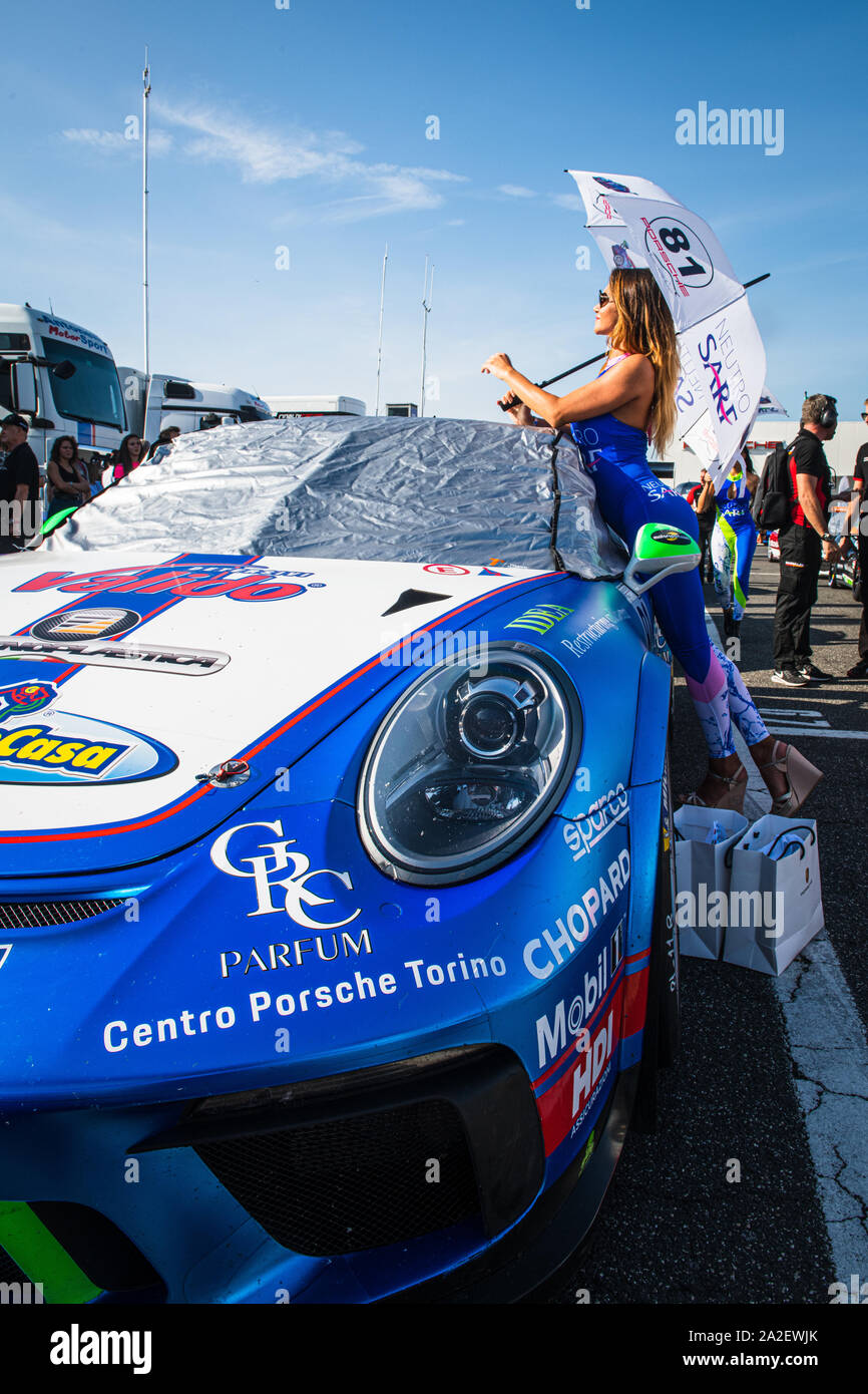 Vallelunga, Italy september 14 2019.  Beautiful grid girl posing with Porsche Carrera racing car in paddock Stock Photo