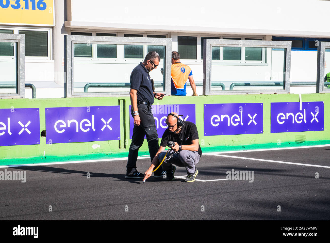 Vallelunga, Italy september 14 2019.  Racing car team people measurement ground temperature on asphalt racing circuit track Stock Photo