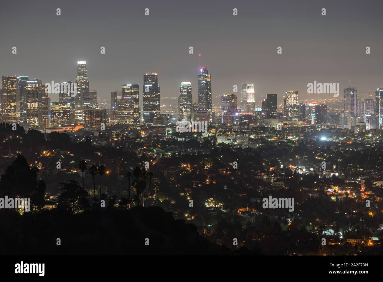 Los Angeles, California, USA - October 2, 2019:  Early morning night view of downtown office towers and hillside homes. Stock Photo