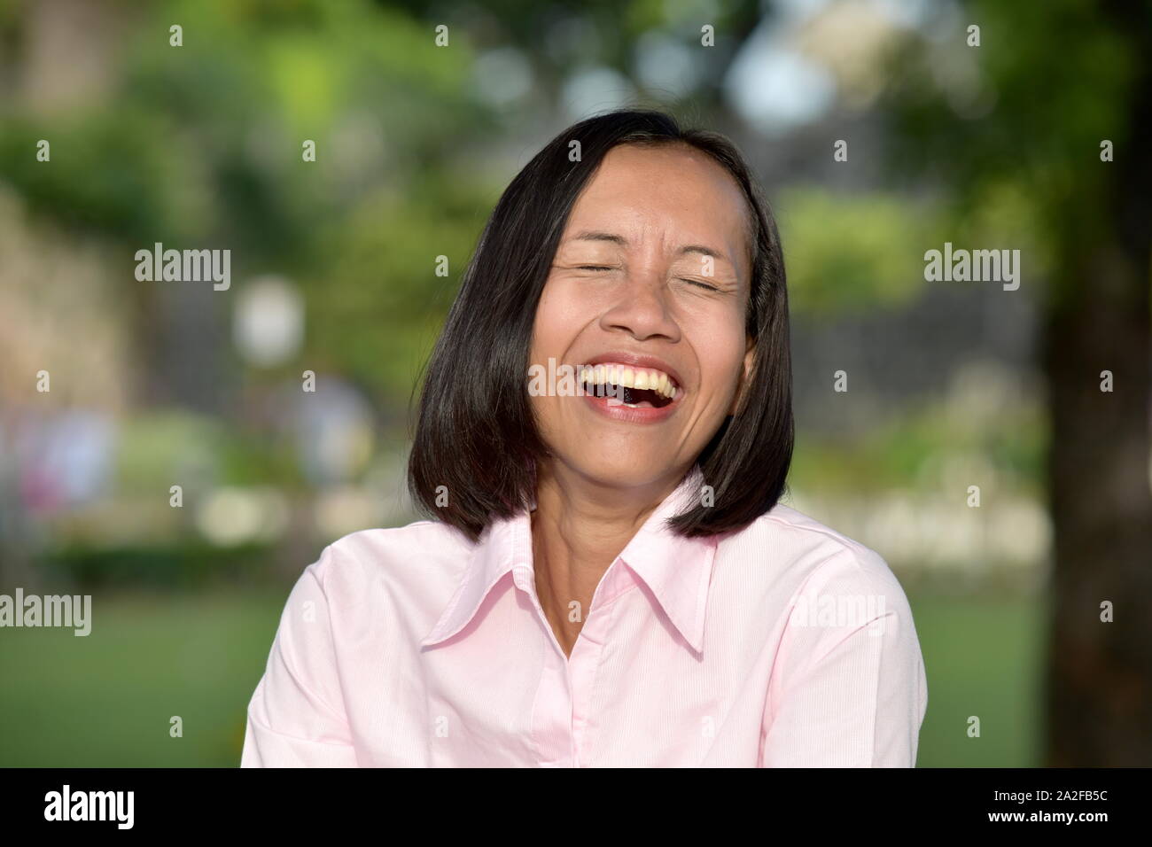 A Youthful Asian Female Laughing Stock Photo