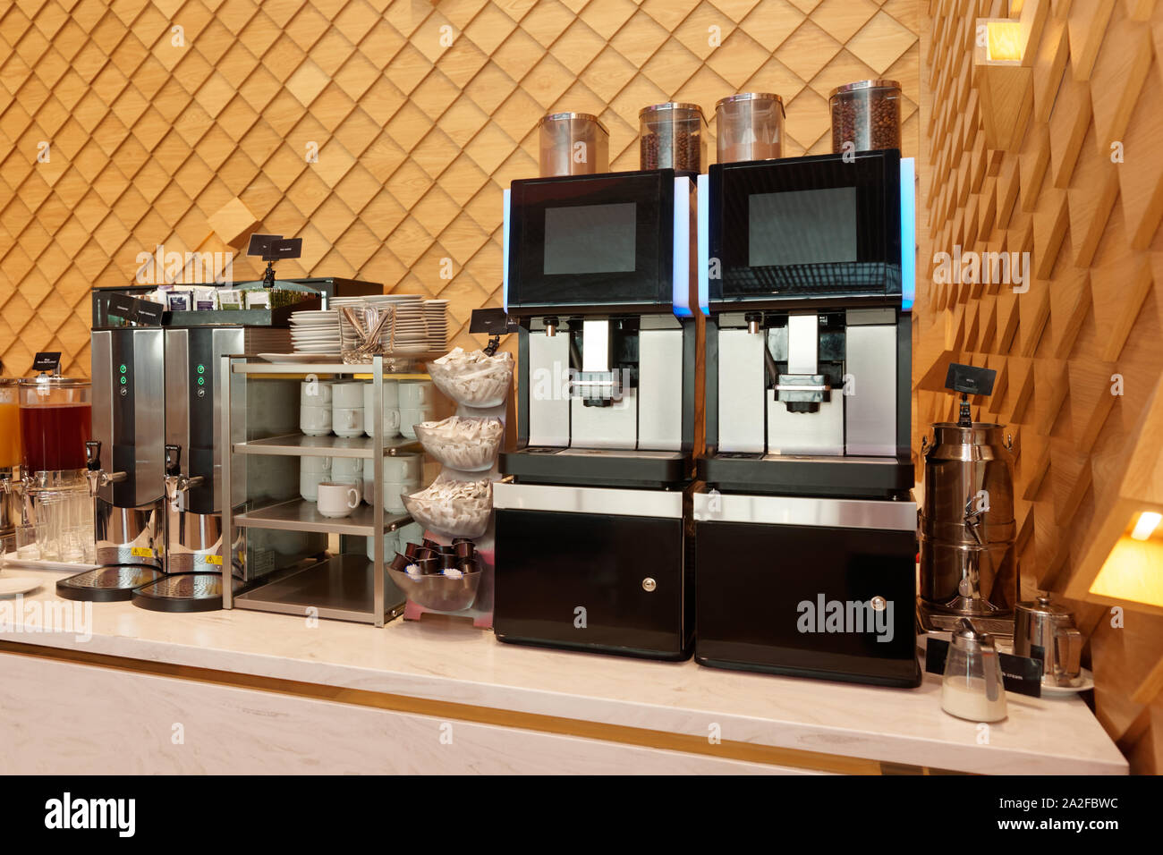 https://c8.alamy.com/comp/2A2FBWC/super-automatic-coffee-machines-and-hot-water-dispensers-in-an-airport-lounge-2A2FBWC.jpg