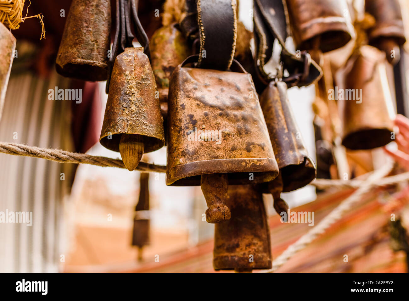 Antique metal cowbells hanging Stock Photo Alamy