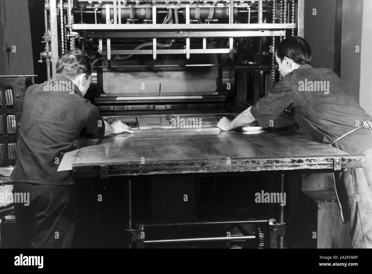 Eine Rotationsdruckmaschine in den Werken des Maschinenbaukonzerns MAN (Maschinenfabrik Augsburg-Nürnberg), Deutschland 1930er Jahre. A rotary printing presses in the plants of the mechanical engineering company MAN (Maschinenfabrik Augsburg-Nürnberg), Germany 1930s. Stock Photo