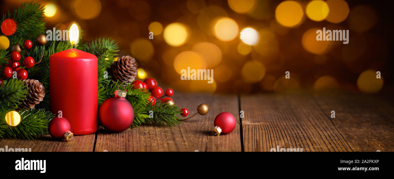 Red burning candle with christmas decoration Stock Photo