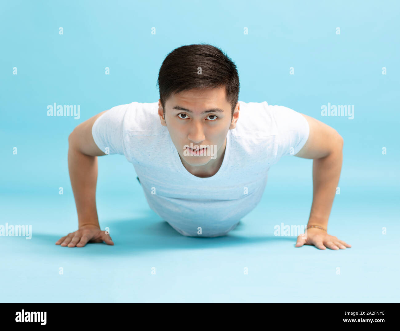 Portrait of young fitness man doing push up Stock Photo