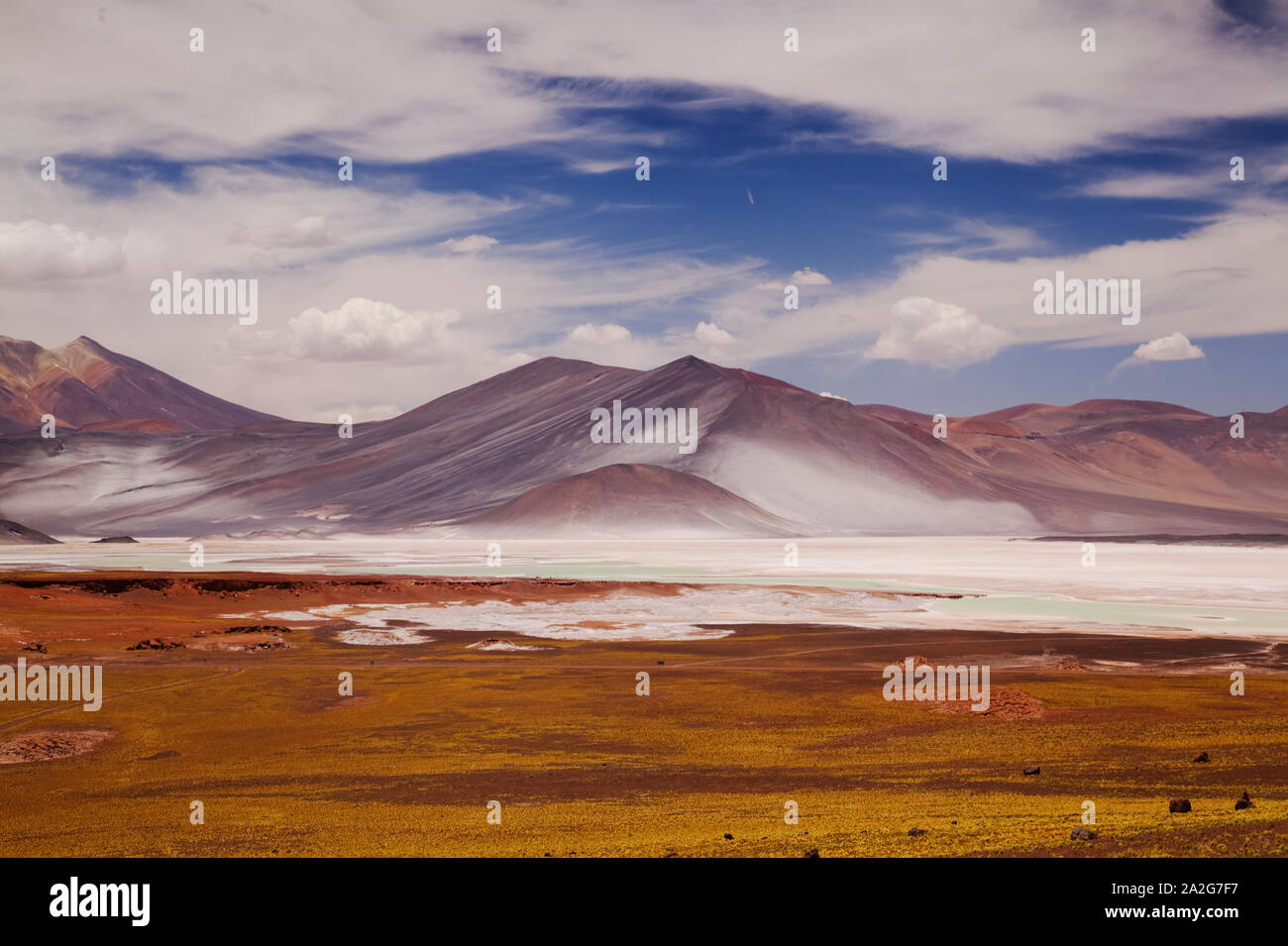 Chile Colorful Rocks Red Rocks (Piedras Rojas) and lagoon and salt flats in Atacama Desert ...