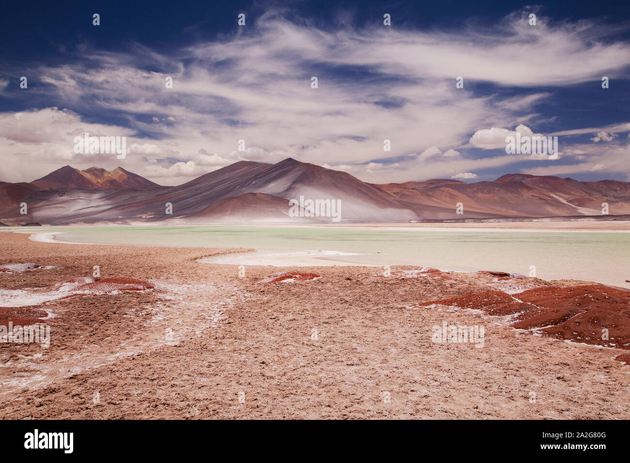 Red Rocks (Piedras Rojas) and lagoon and salt flats in Atacama Desert ...