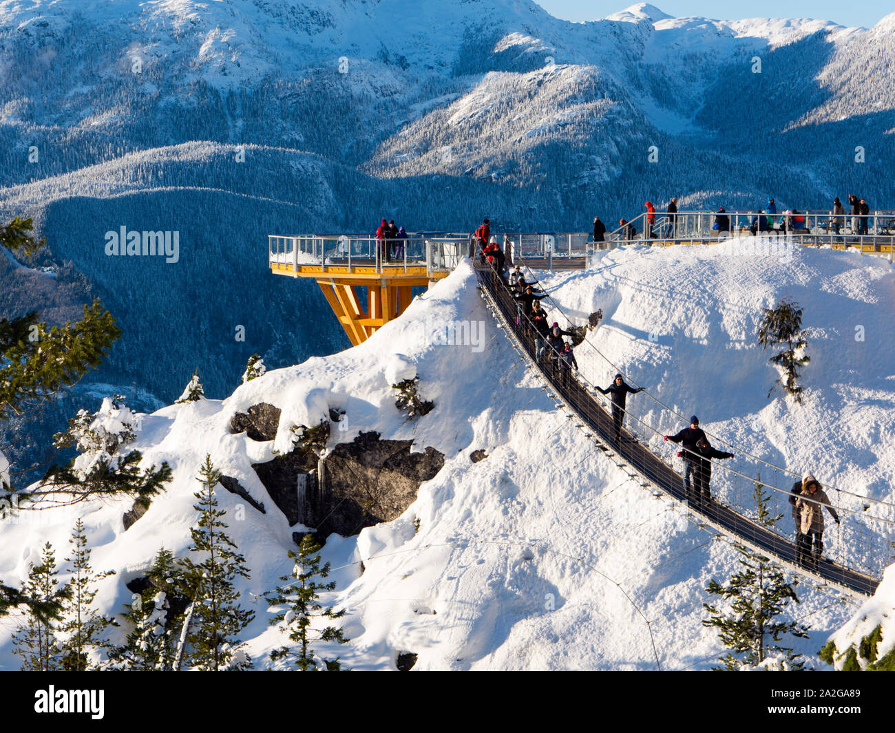 Suspension bridge and overlook at the Sea to Sky Gondola summit lodge in winter. Stock Photo