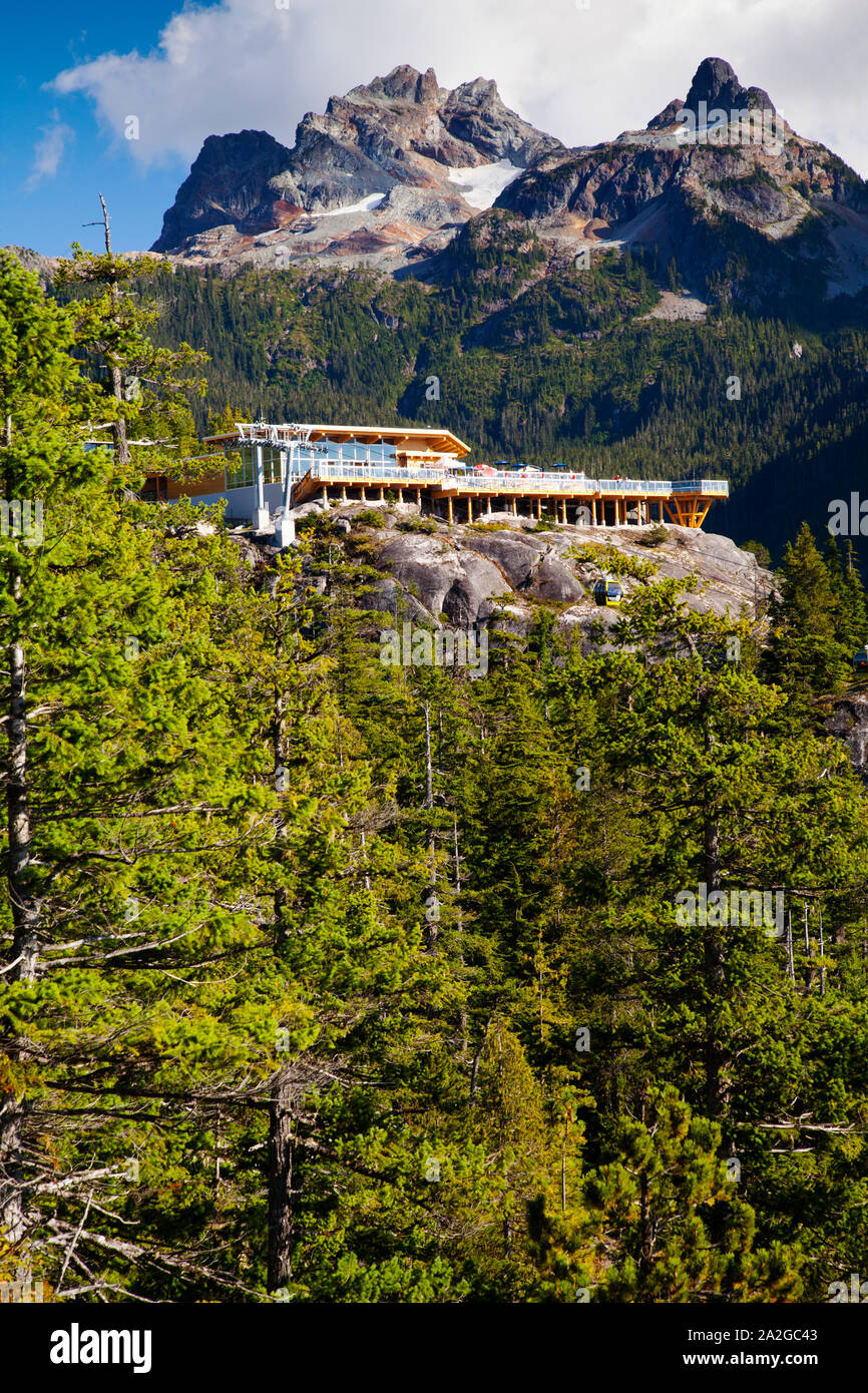 The summit lodge of the gondola with Sky Pilot and Co-pilot mountains looming over it, Squamish, BC. Stock Photo