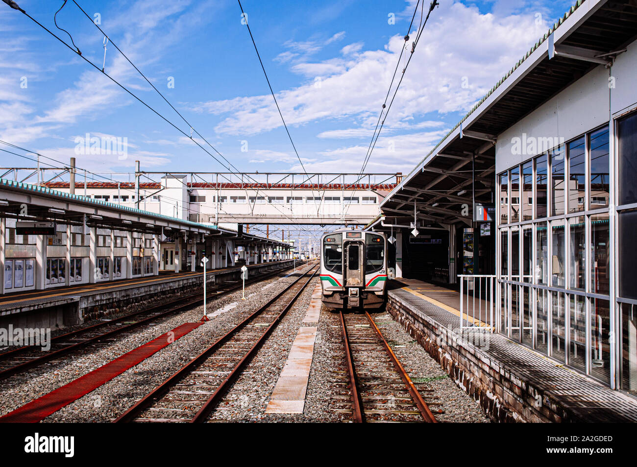 DEC 4, 2018 Kakunodate, Japan - Aizu Wakamatsu train Station platform and JR train for Koriyama on winter blue sky day Stock Photo