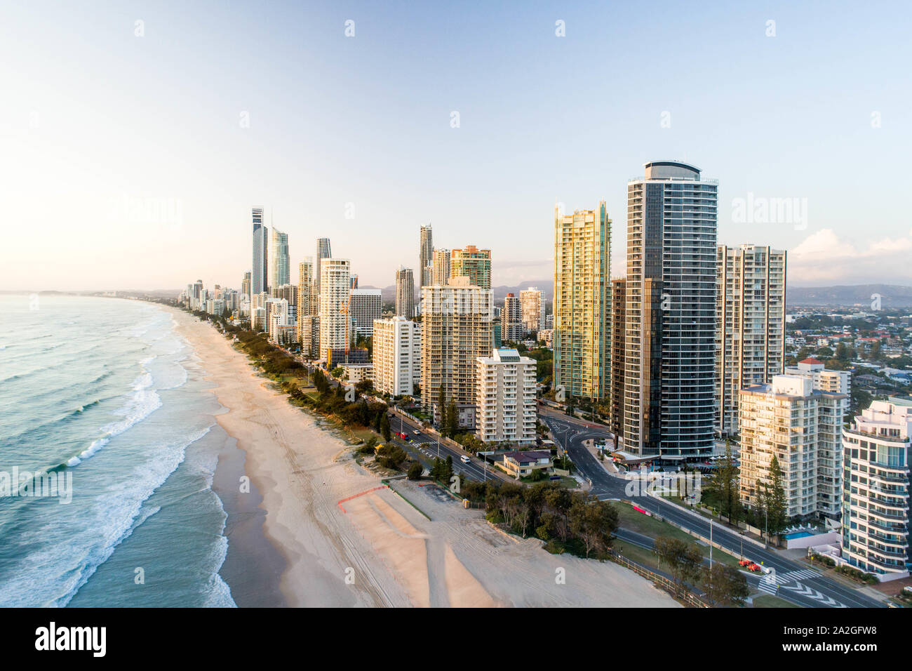 Aerial sunrise of skyline right on the beach. Nice morning light on the Gold Coast holiday hotel destination by the ocean. Stock Photo