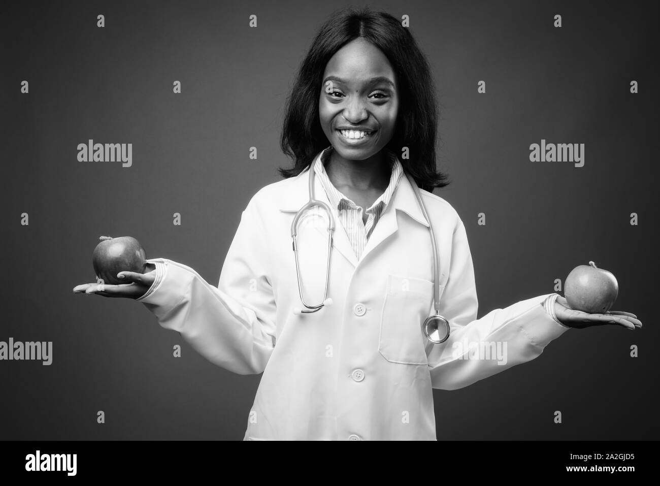 Young beautiful African Zulu woman doctor against brown background ...