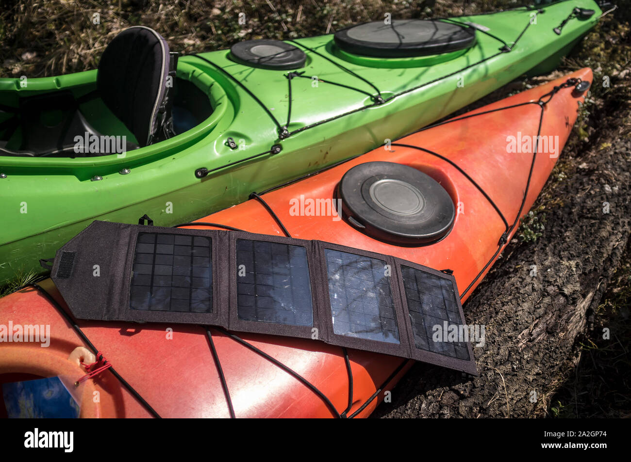 Portable solar panels lie on an orange kayak and accumulate energy Stock  Photo - Alamy