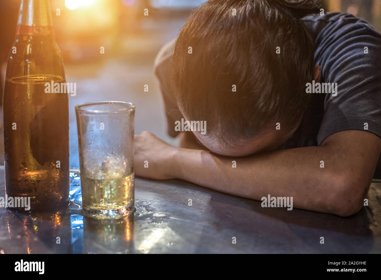 Drunk Man Sleeping At Bar Counter Stock Photo