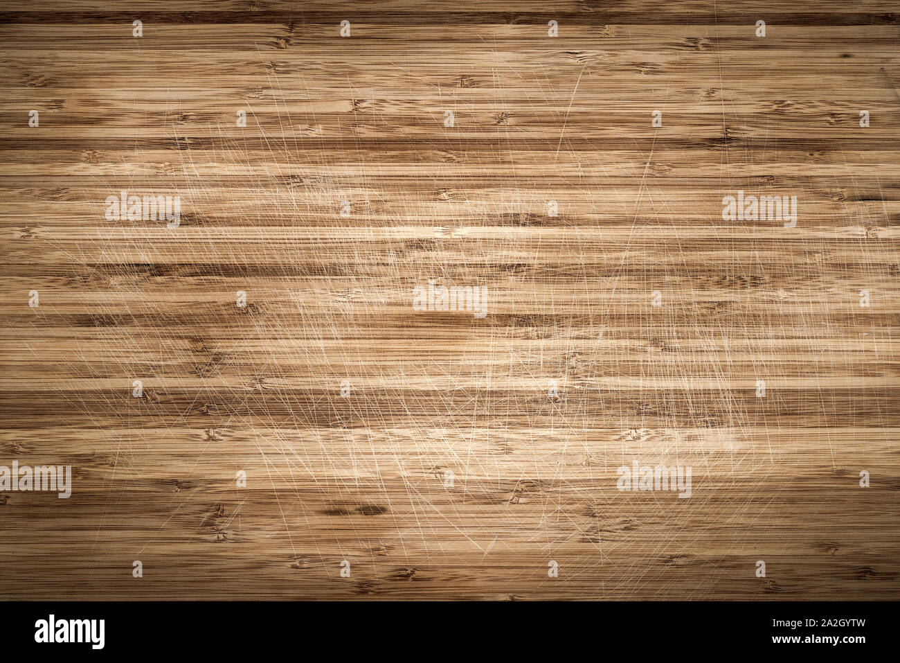Old scratched wooden cutting board as background Stock Photo