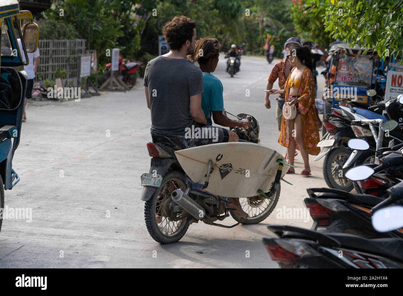 A motorcycle adapted to carry surfboards near to Cloud 9,Siargao