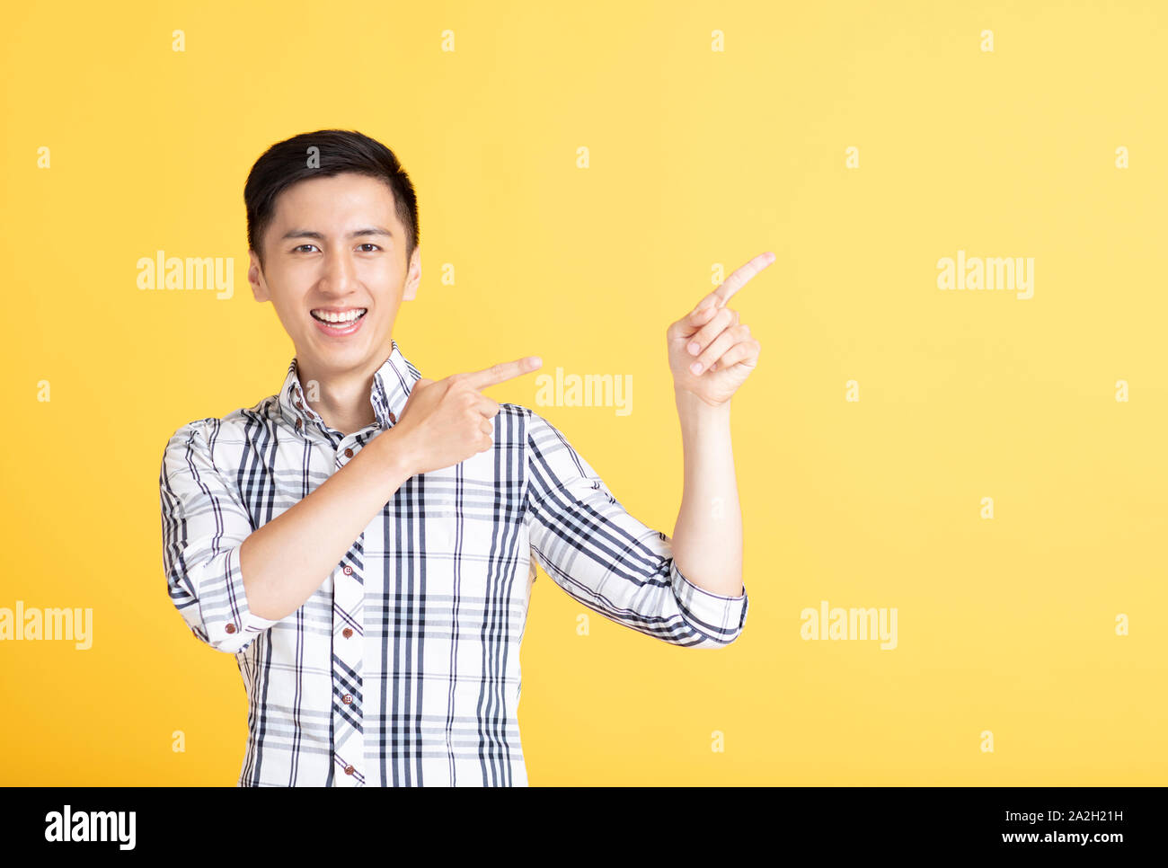 handsome young man pointing and showing Stock Photo