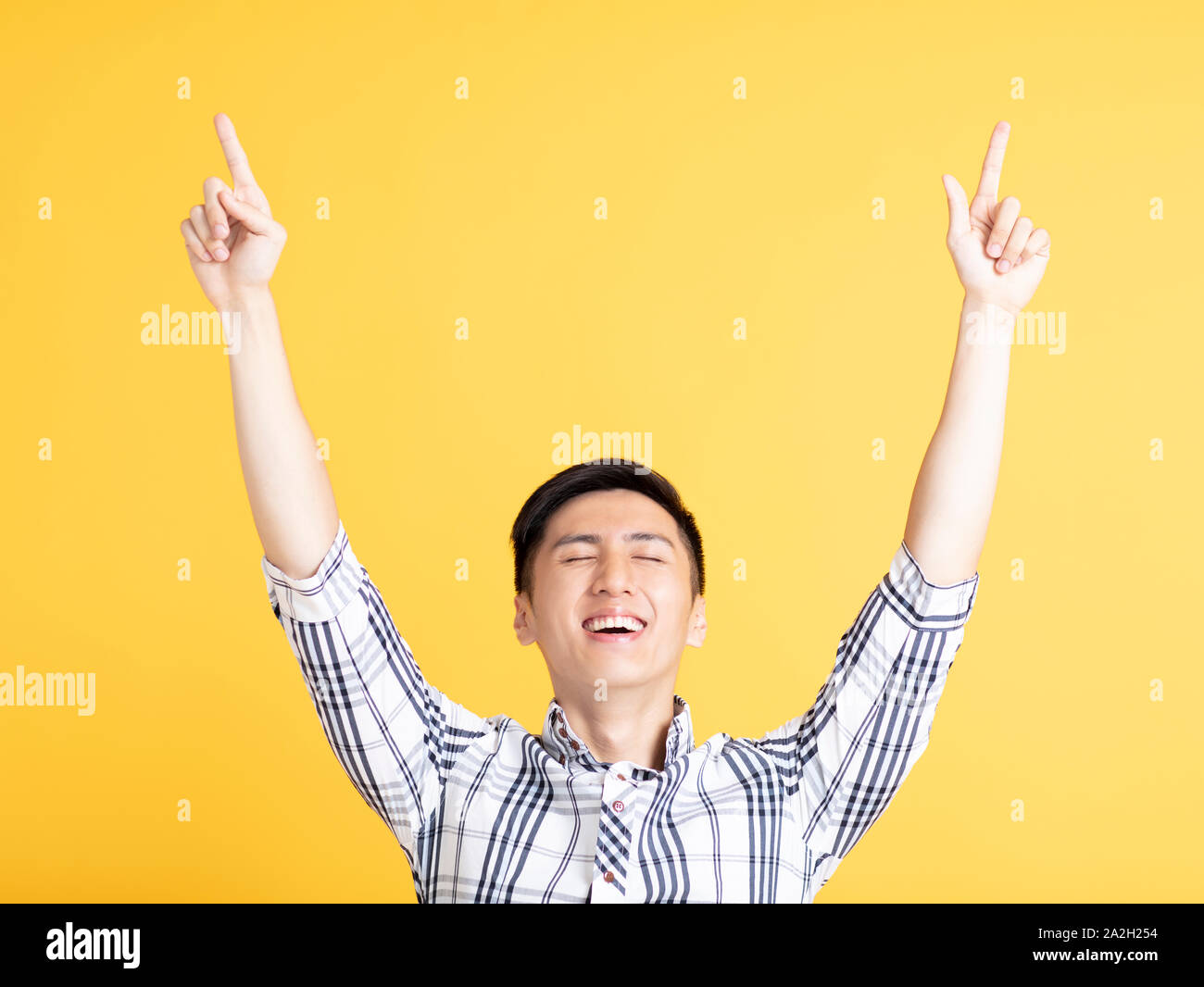 handsome young man pointing up Stock Photo