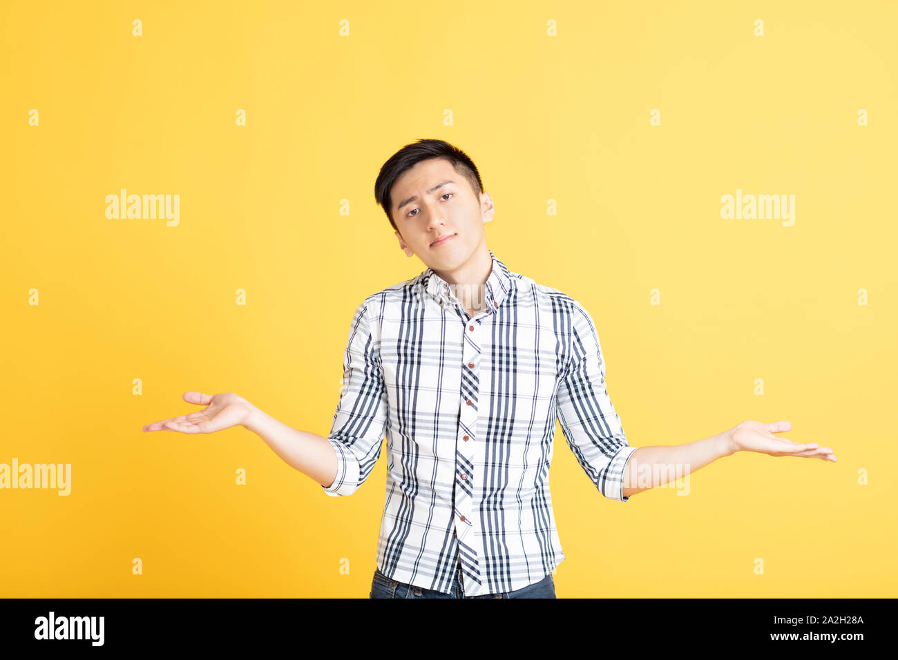 confused young man shrugging shoulders Stock Photo
