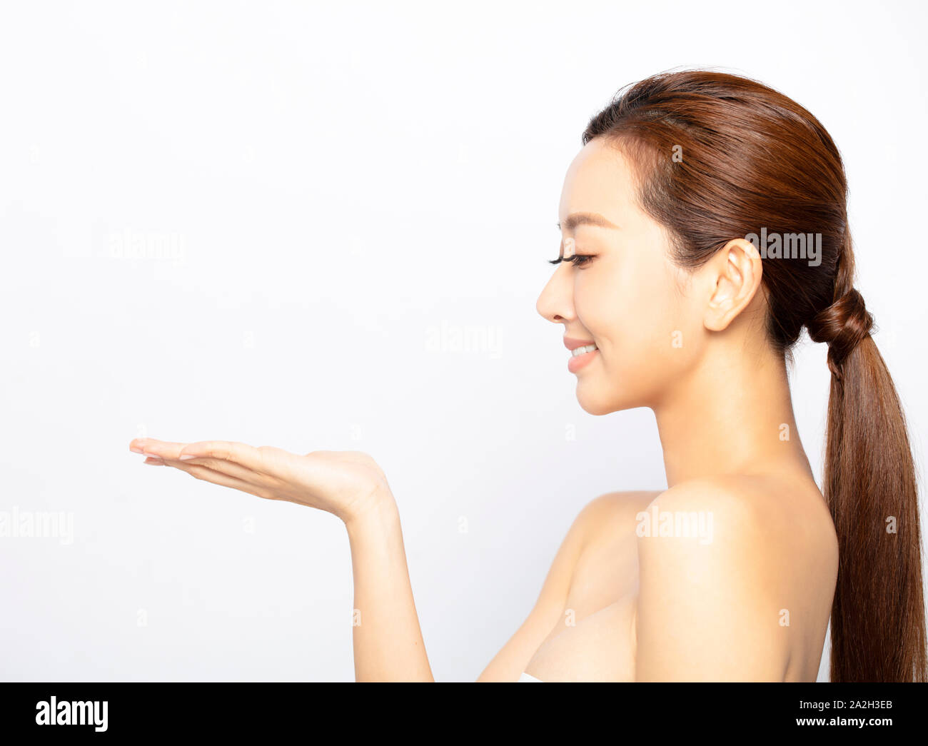 beauty Asian woman showing product on open hand Stock Photo