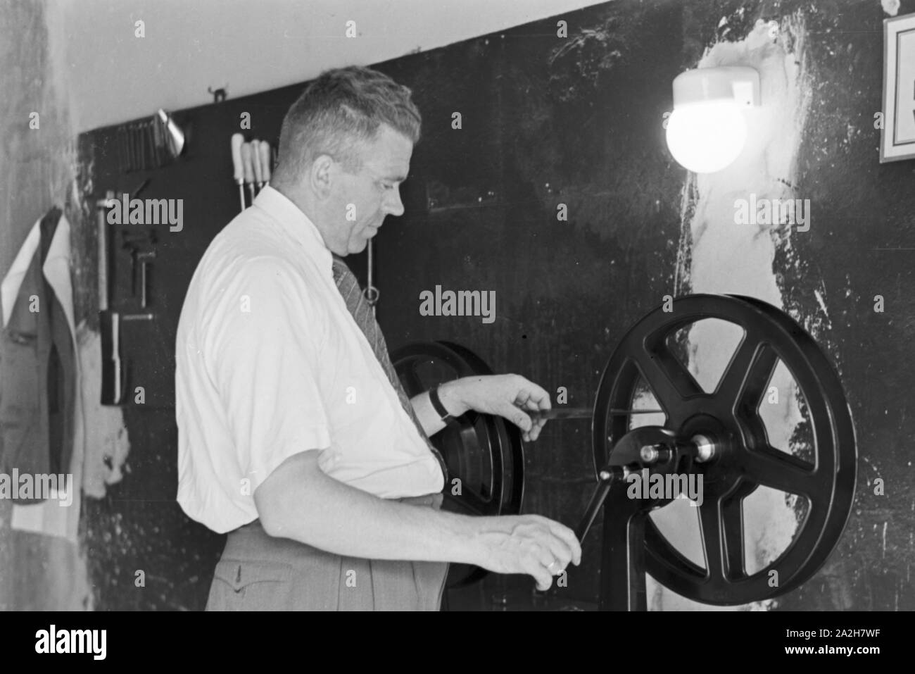 Mitarbeiter der Wetterdienststelle beim Einlegen eines Films, Deutschland 1930er Jahre. Staff member of a meteorological office inserting a film, Germany 1930s. Stock Photo