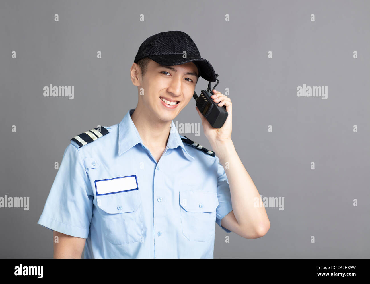 Male security guard using portable radio transmitter Stock Photo Alamy