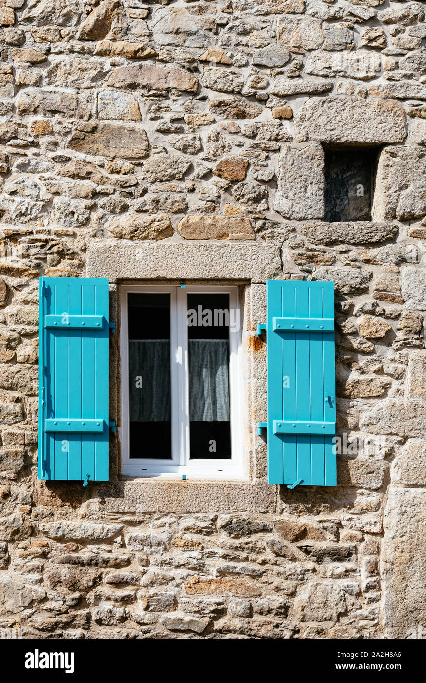 Old window with wooden blue painted shutter in stone wall Stock Photo ...