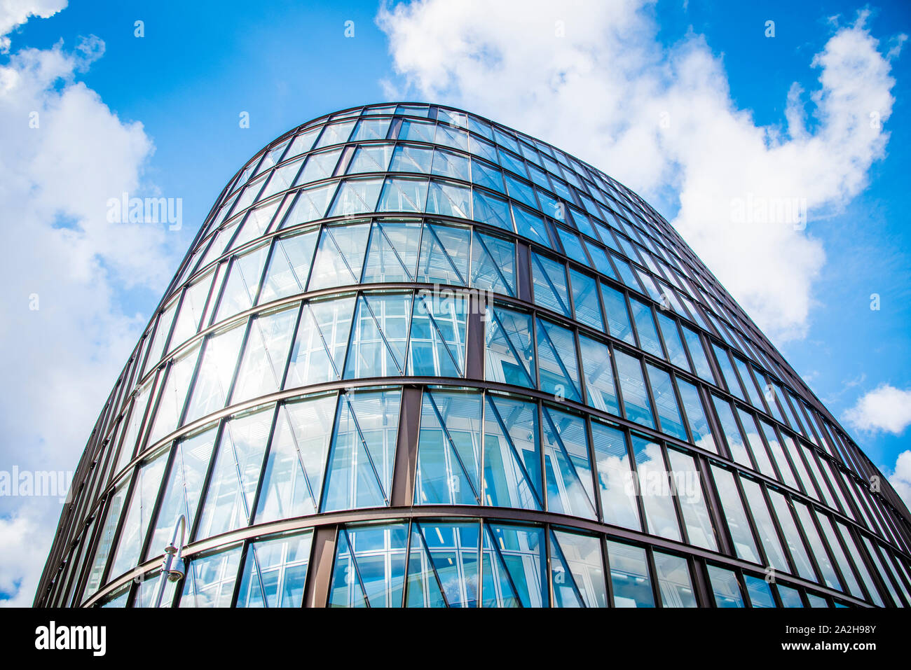 Modern Building with glass windows on a cloudy bright sky in Manchester ...