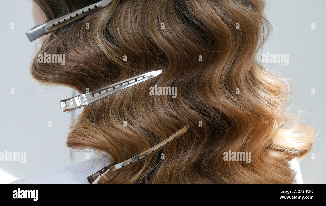 Silver Hairdressers Clips In Wavy Hair Close Up Stock Photo