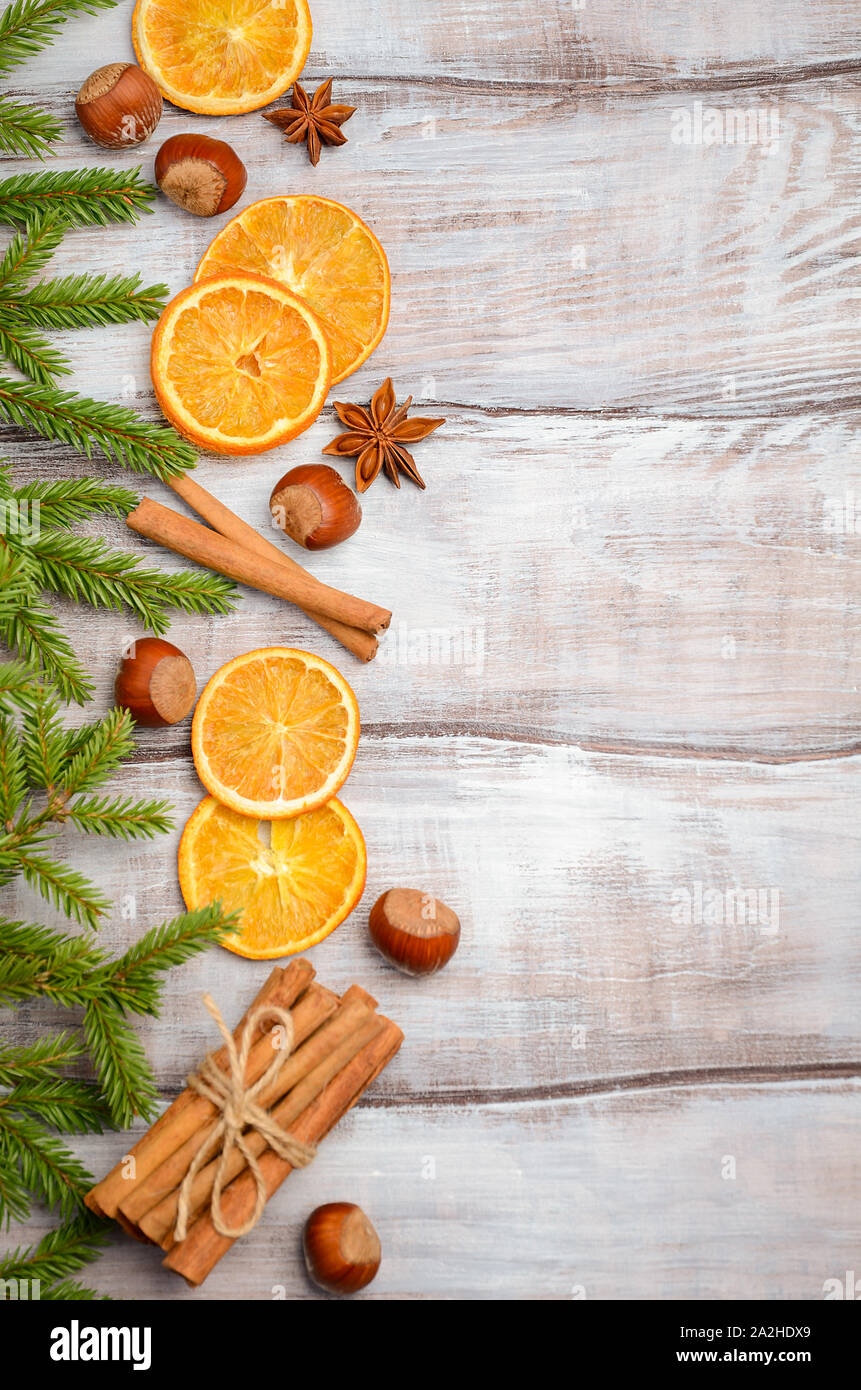 Christmas background with Fir Branches, Nuts, Spices and Dried oranges Top view Flat lay Copy space Stock Photo