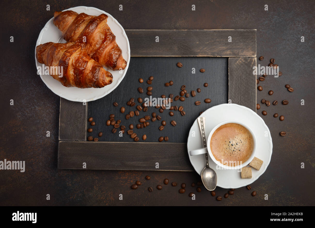 Cup of fresh coffee with croissant on concrete background Top view Stock Photo