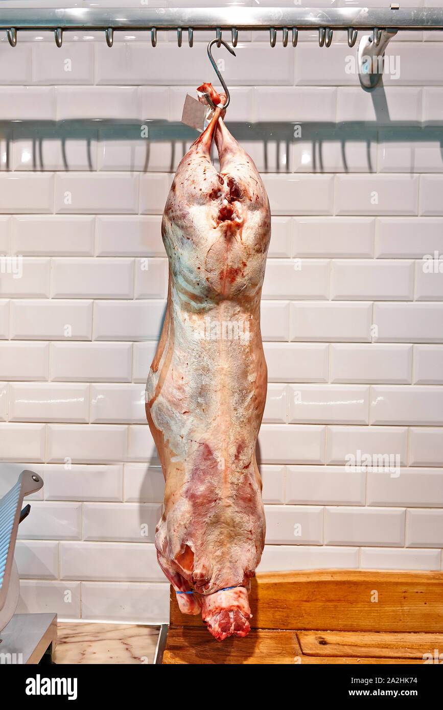 Pork pig carcasses hanging on meat hooks in a factory Stock Photo - Alamy