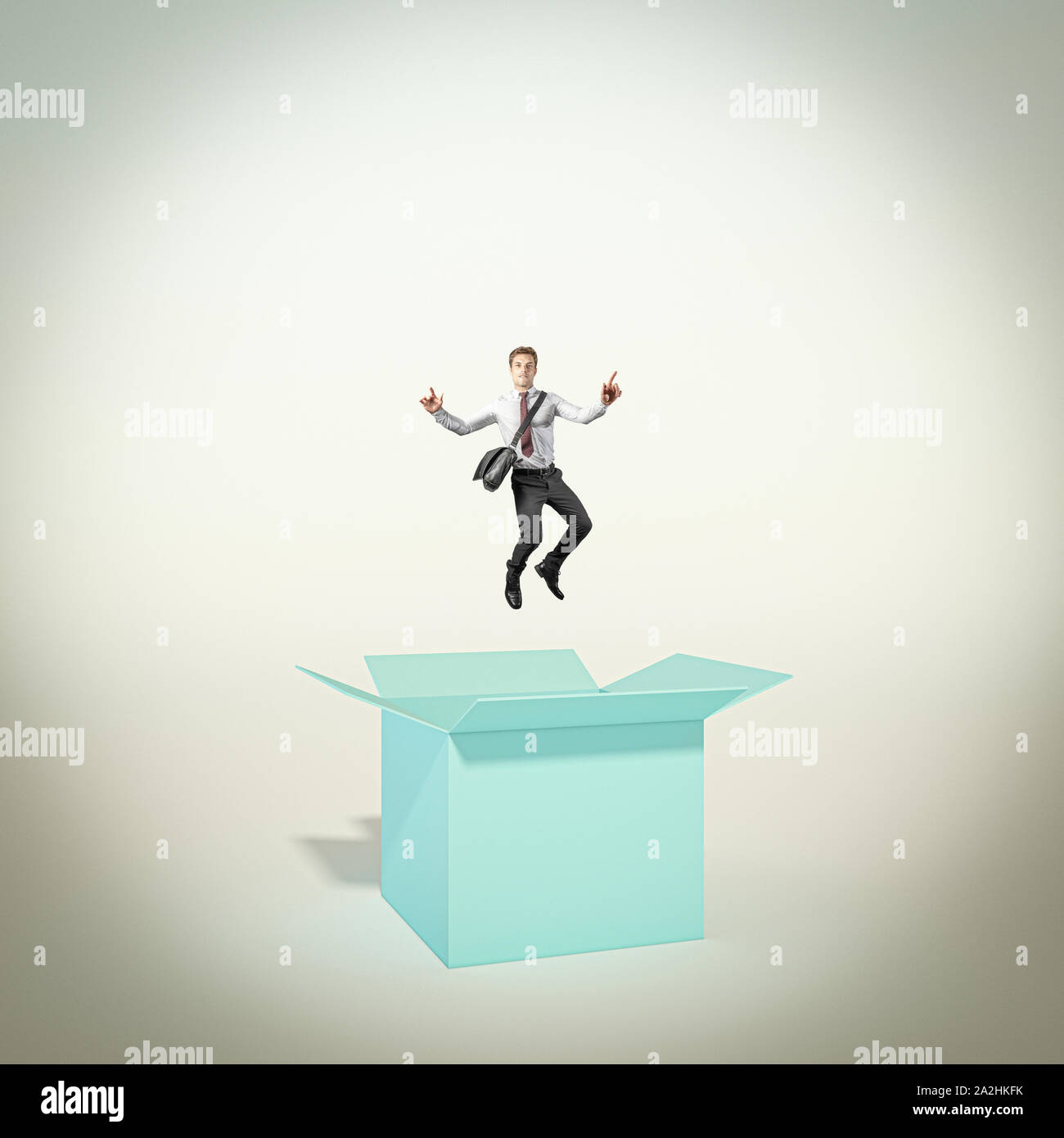 Happy and successful man jumps out of the box. concept of different and creative thinking. winning attitude. Stock Photo