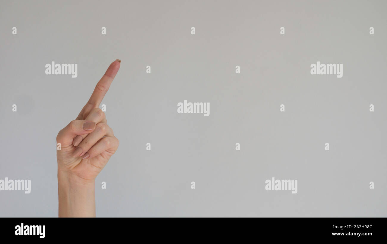 Woman's index finger on a light gray background Stock Photo - Alamy