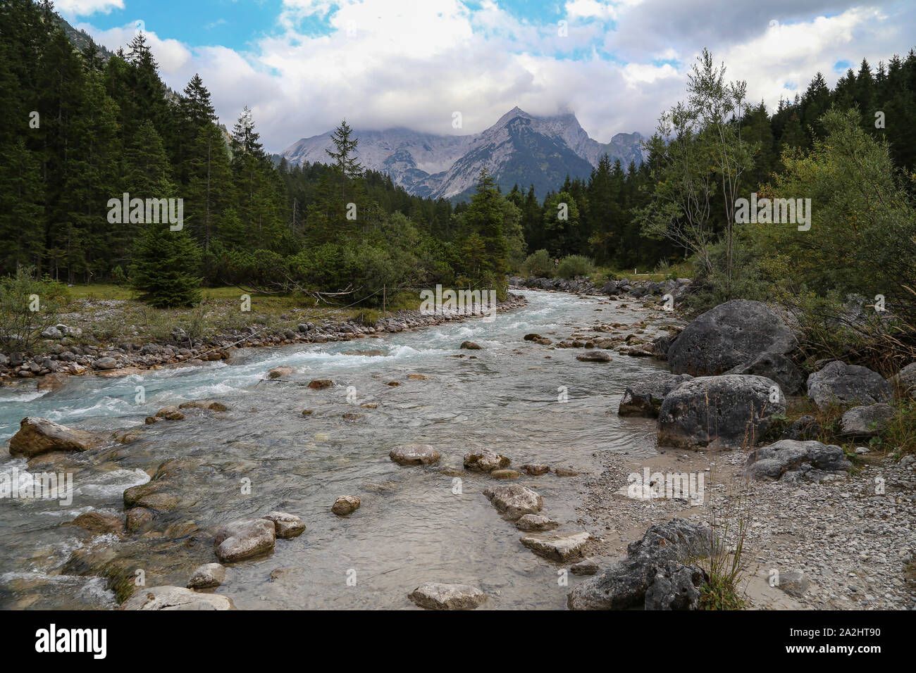 Mountain landscape with a small river in the Alps Stock Photo - Alamy