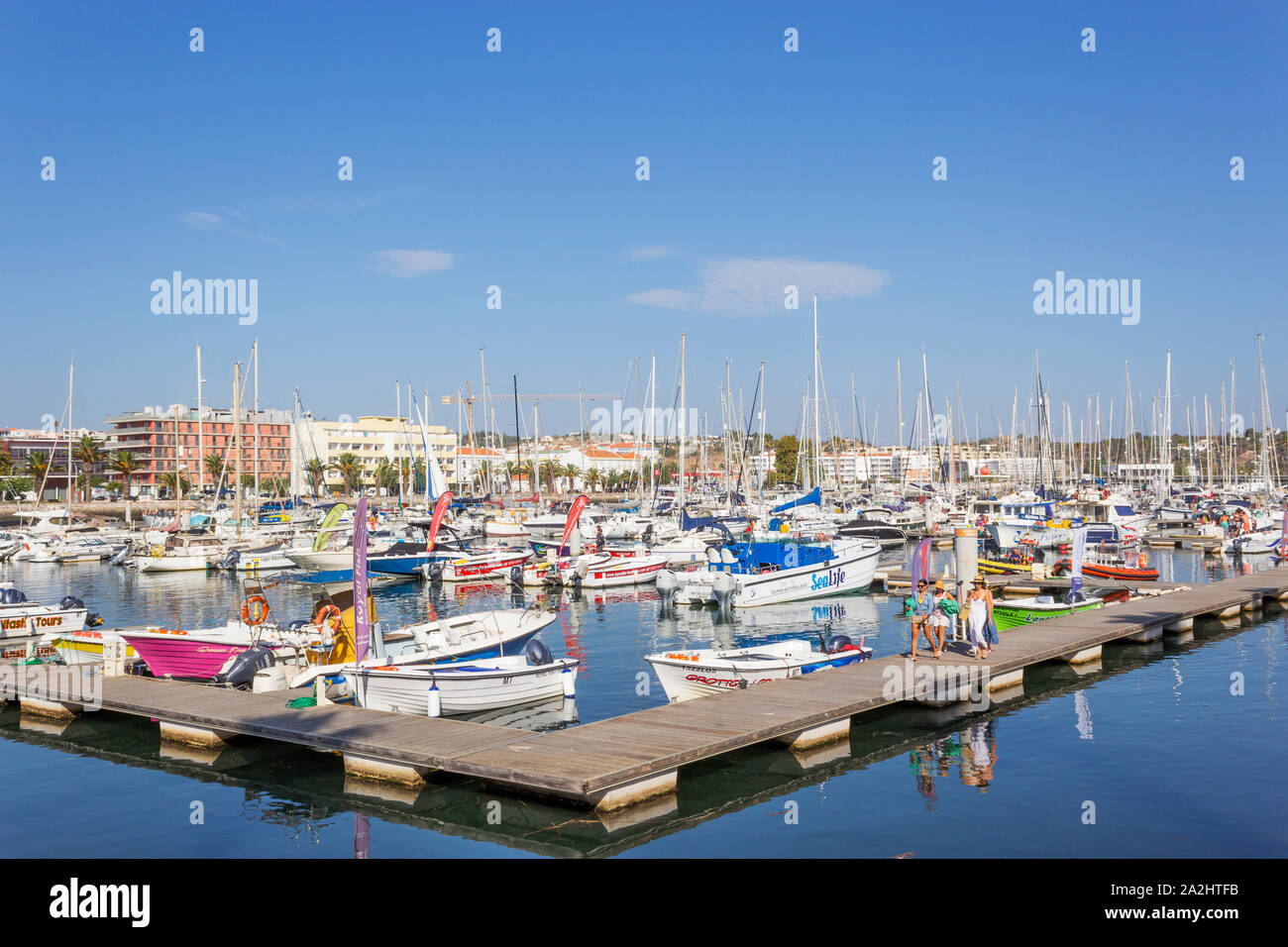 Marina de Lagos, Lagos, Algarve, Portugal. Small boats moored in the marina. Stock Photo