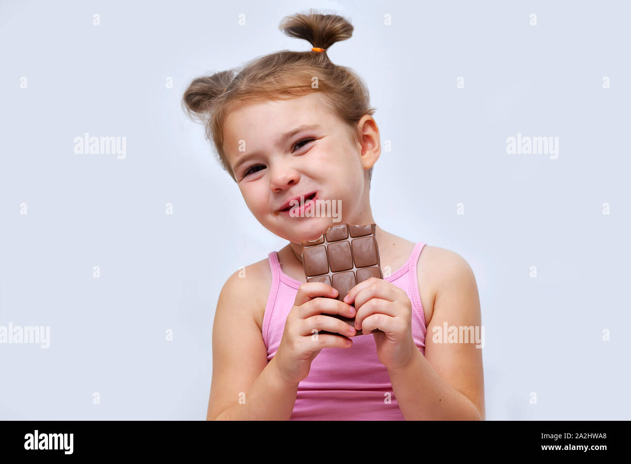 little girl eating chocolate isolated on white Stock Photo