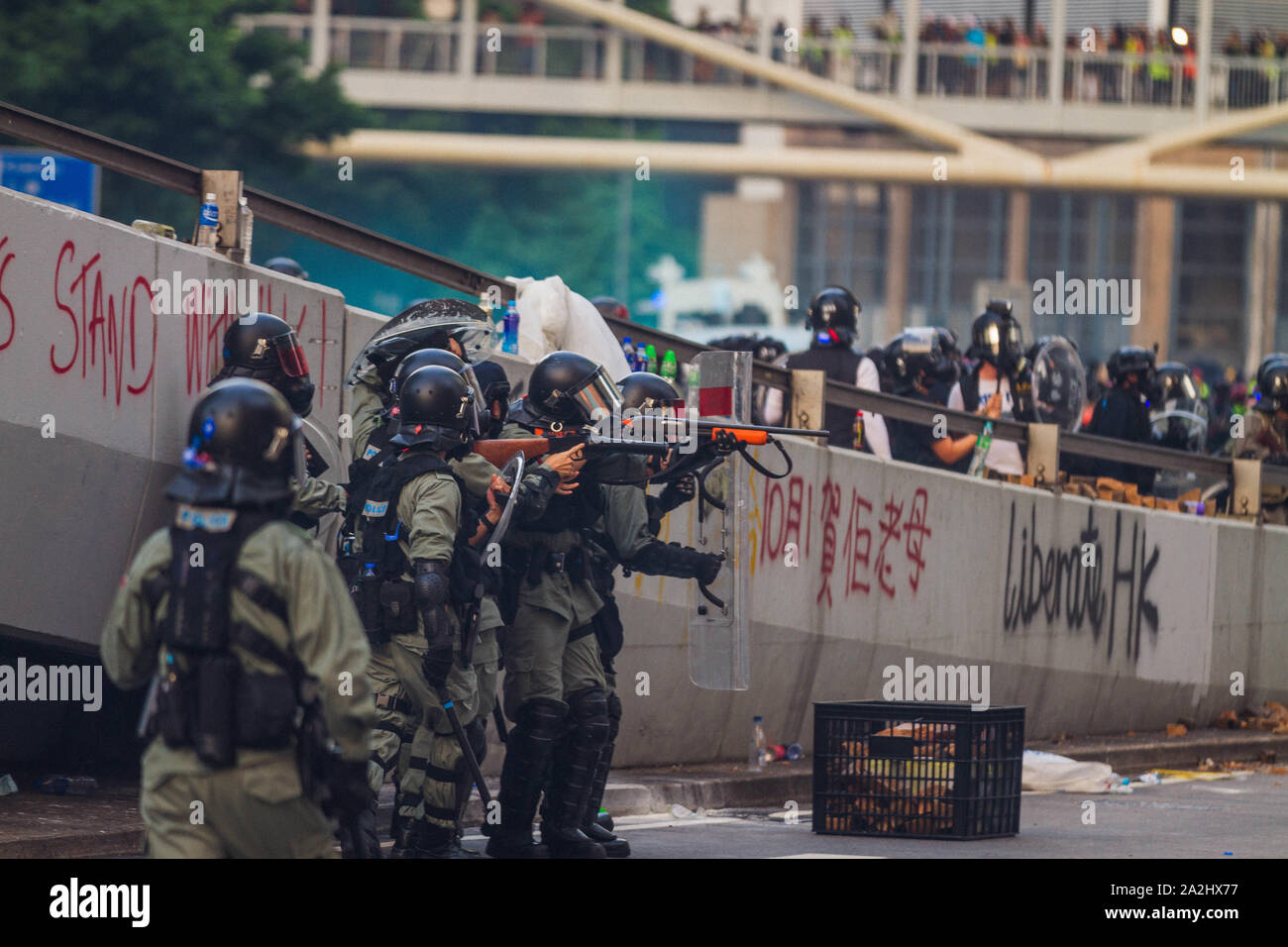 Riot police taking aim on protesters in Hong Kong Stock Photo