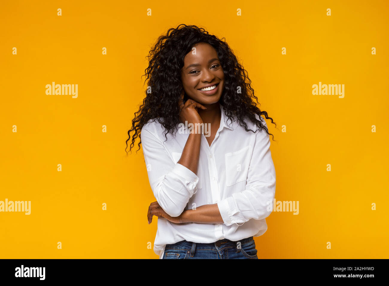 Happy smiling african american woman touching her neck Stock Photo - Alamy