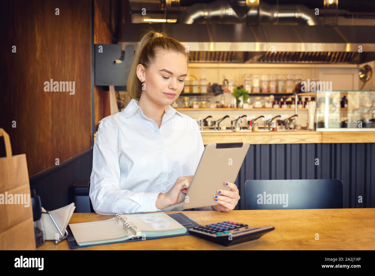 Small business owner using digital tablet to pay taxes online Stock Photo