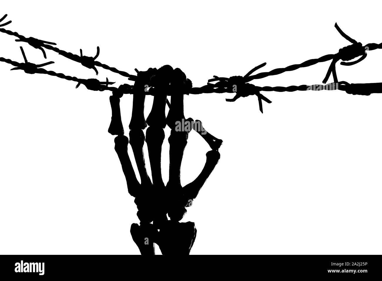 Freedom image with a silhouette of a skeleton hand holding barbed wire Stock Photo