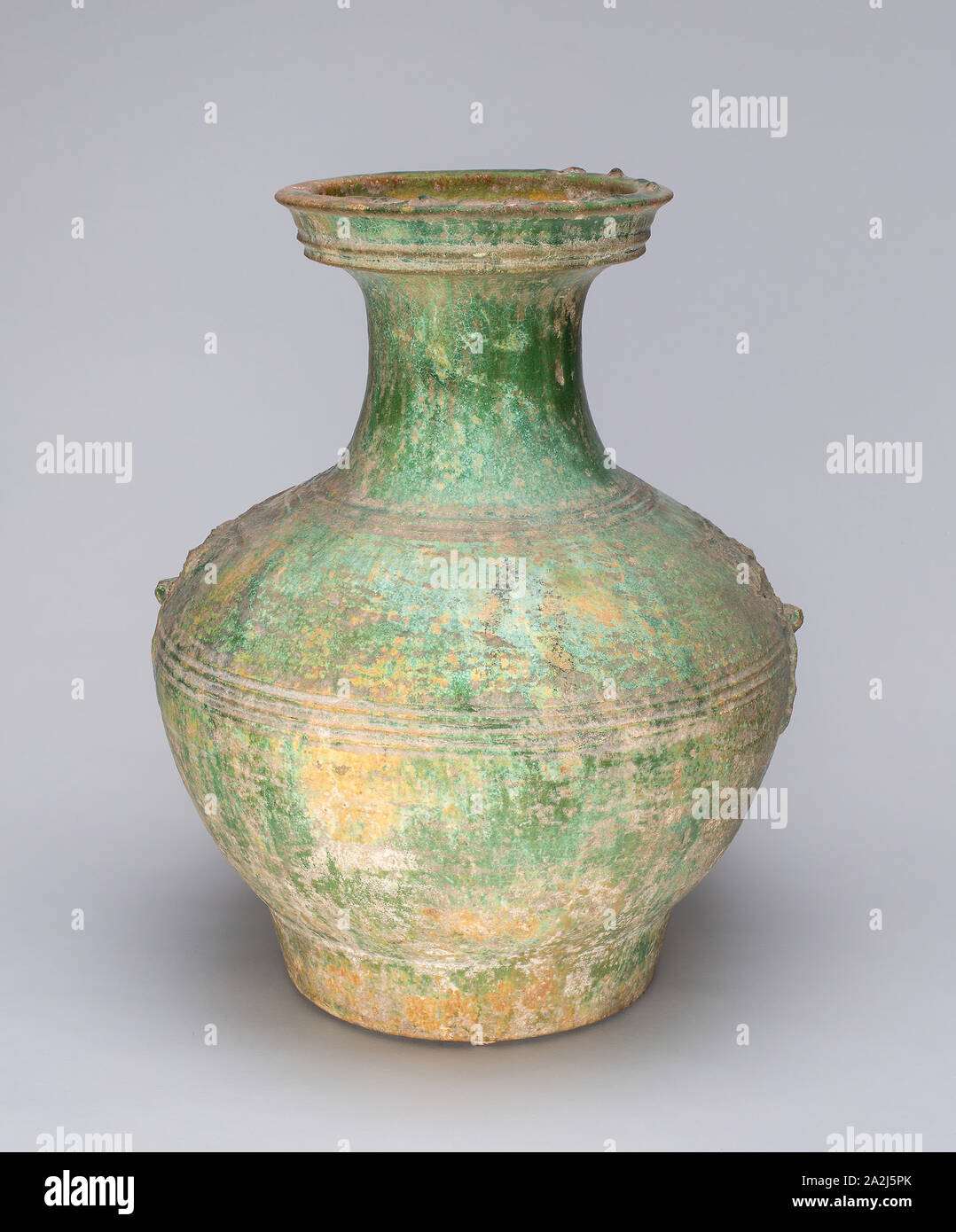 Globular Jar with Mock Ogre Mask Ring Handles, Han dynasty (206 B.C.–A.D. 220), China, Earthenware with underglaze molded decoration and lead green glaze, H. 39.1 cm (15 3/8 in.), diam. 30.7 cm (12 1/8 in Stock Photo