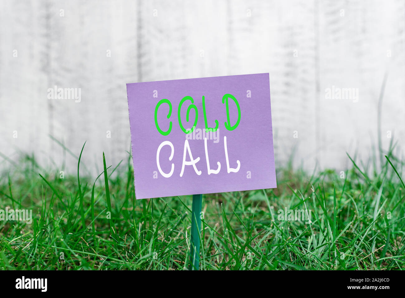Writing note showing Cold Call. Business concept for Unsolicited call made by someone trying to sell goods or services Plain paper attached to stick a Stock Photo